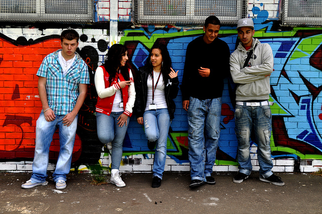 Teenagers standing close to a high school wall